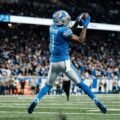 Jameson Williams Detroit Lions wide receiver catching football during NFL game action shot