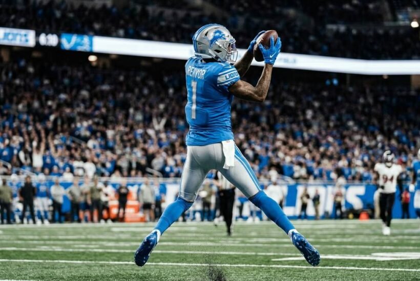 Jameson Williams Detroit Lions wide receiver catching football during NFL game action shot