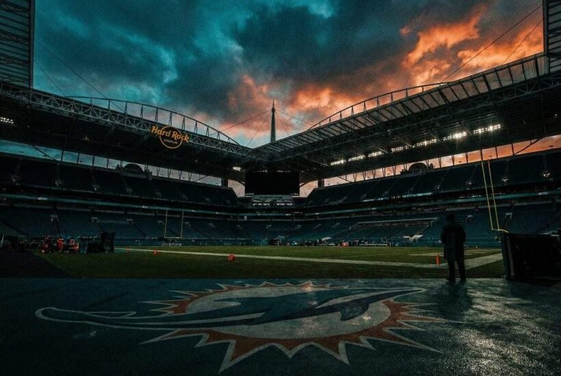 Hard Rock Stadium at dusk, home of the Miami Dolphins, under a dramatic stormy sky