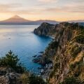 highlights of nummazaki — dramatic coastal cliffs above Suruga Bay with Mount Fuji visible across the water at golden hour