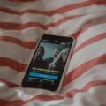 Drama episode open on a phone screen in bed while searching for apps like Loklok