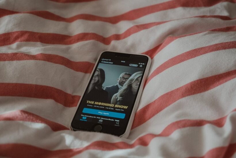 Drama episode open on a phone screen in bed while searching for apps like Loklok