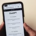 Hands holding a phone with a ChatGPT conversation open, the starting point for finding apps similar to ChatGPT for free