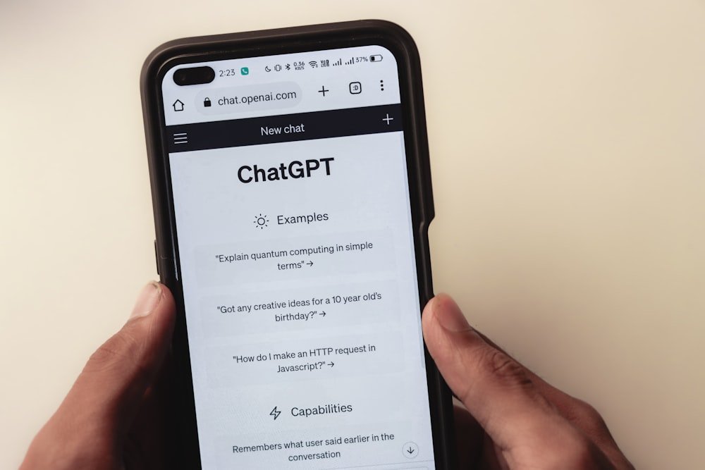 Hands holding a phone with a ChatGPT conversation open, the starting point for finding apps similar to ChatGPT for free