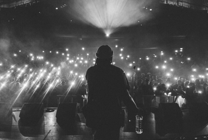 tony yayo net worth — rapper silhouetted on stage before a crowd of raised phone lights