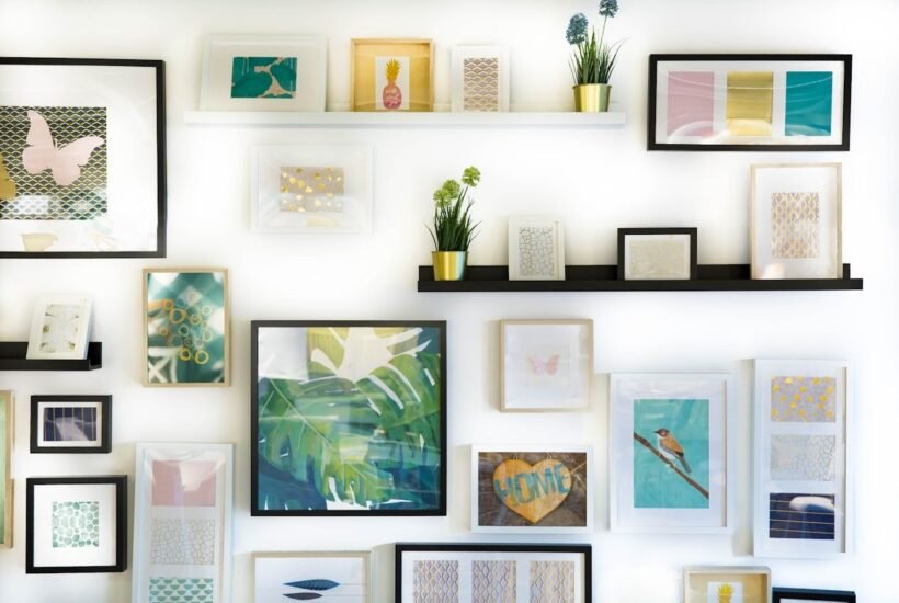 A gallery wall of framed prints and a handmade wooden sign, the kind of work sellers list on sites like Etsy