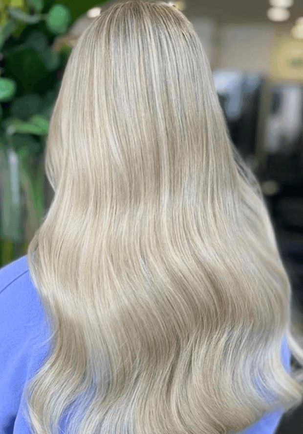 Long icy-blonde hair from behind after full head highlights, a Rush Hair & Beauty photo