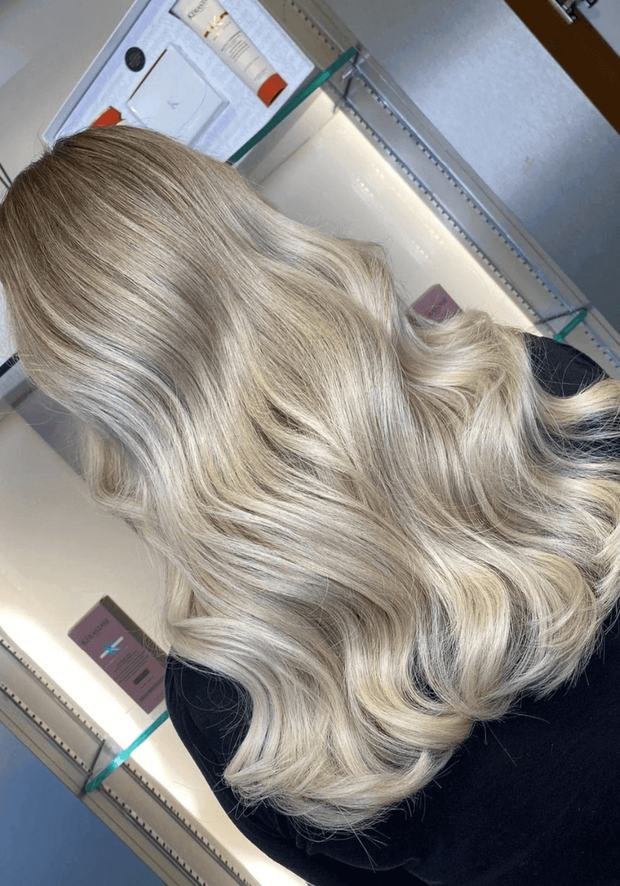 Long wavy ash-blonde hair from behind after a toner, a Rush Hair & Beauty photo